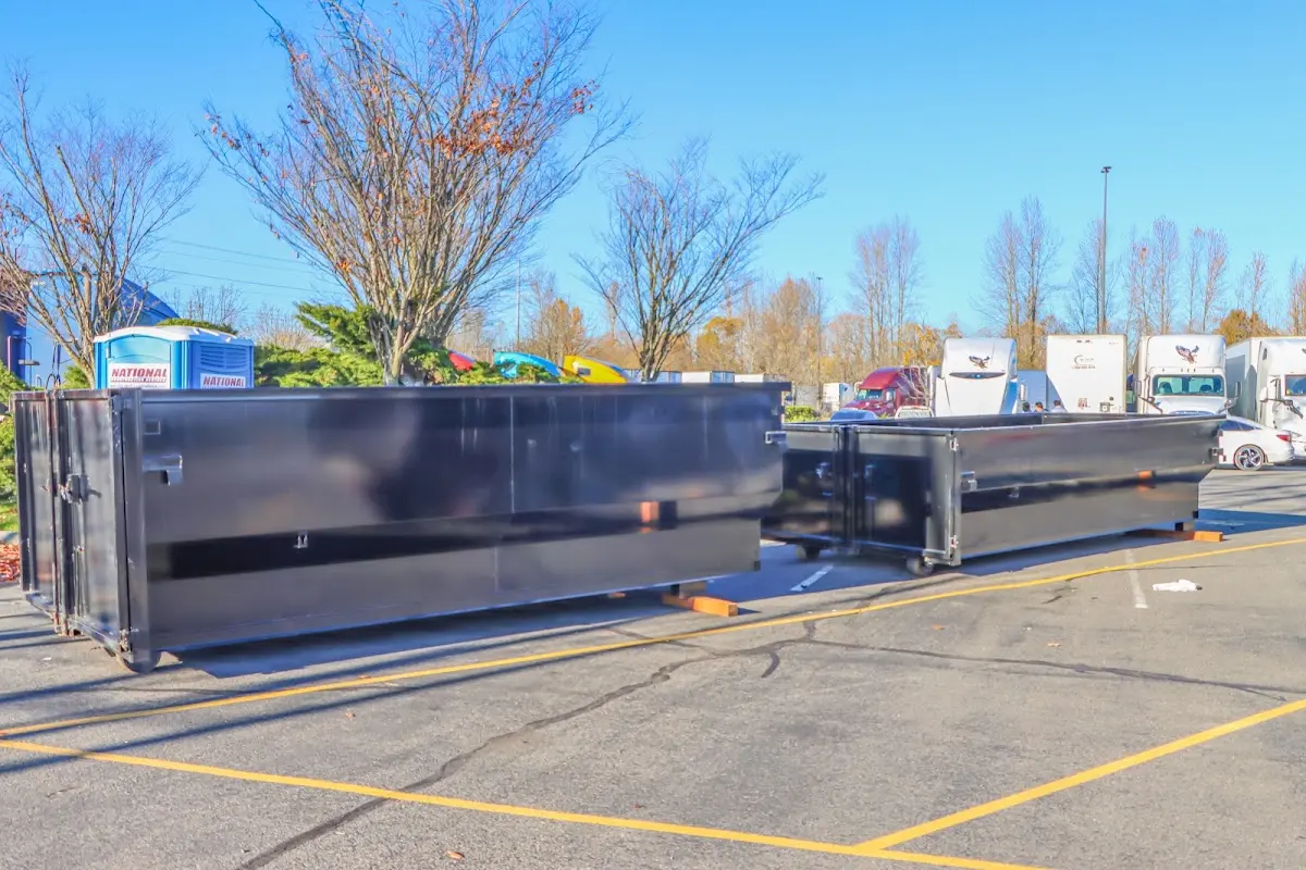 Professional dumpster rental service with roll-off container on residential driveway in Woodlake